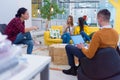 Group of a young business multiethnic people brainstorming and discussing business plan on meeting at sunny bright office interior Royalty Free Stock Photo