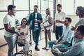 Group of Young Business People on Break in Office Royalty Free Stock Photo