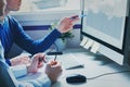 Group of young business people coworkers looking together at computer