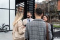 Group of young business people, job candidates standing in front of the office building waiting to be called to meeting with the Royalty Free Stock Photo