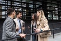 Group of young business people, job candidates standing in front of the office building waiting to be called to meeting with the Royalty Free Stock Photo