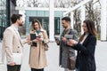 Group of young business people, job candidates standing in front of the office building waiting to be called to meeting with the Royalty Free Stock Photo