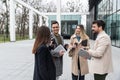 Group of young business people, job candidates standing in front of the office building waiting to be called to meeting with the Royalty Free Stock Photo