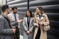 Group of young business people, job candidates standing in front of the office building waiting to be called to meeting with the Royalty Free Stock Photo