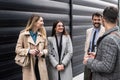 Group of young business people, job candidates standing in front of the office building waiting to be called to meeting with the Royalty Free Stock Photo