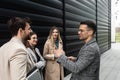 Group of young business people, job candidates standing in front of the office building waiting to be called to meeting with the Royalty Free Stock Photo