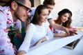 Group of young business people , Startup entrepreneurs working on their venture in coworking space.