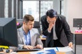 Group of young business people working and communicating while sitting at the office desk together Royalty Free Stock Photo