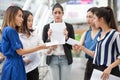 happy young businesswoman is showing money and laptop with blank copy space screen and clipping path in urban city. girl holding