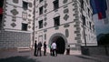 Group of young business women and men entering castle for a meeting