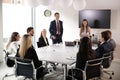 Group Of Young Businessmen And Businesswomen Meeting Around Table At Graduate Recruitment Assessment Day Royalty Free Stock Photo