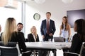 Group Of Young Businessmen And Businesswomen Meeting Around Table At Graduate Recruitment Assessment Day Royalty Free Stock Photo