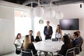 Group Of Young Businessmen And Businesswomen Meeting Around Table At Graduate Recruitment Assessment Day Royalty Free Stock Photo