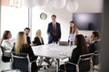 Group Of Young Businessmen And Businesswomen Meeting Around Table At Graduate Recruitment Assessment Day Royalty Free Stock Photo