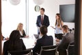 Group Of Young Businessmen And Businesswomen Meeting Around Table At Graduate Recruitment Assessment Day Royalty Free Stock Photo