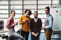 A group of young businesspeople with cup of coffee standing in office. Royalty Free Stock Photo