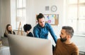 Group of young businesspeople with laptop working in a modern office. Royalty Free Stock Photo