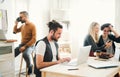 Group of young businesspeople with laptop working in a modern office. Royalty Free Stock Photo