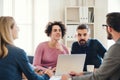 Group of young businesspeople with laptop working together in a modern office. Royalty Free Stock Photo