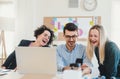 Group of young businesspeople with laptop working together in a modern office. Royalty Free Stock Photo