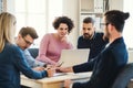 Group of young businesspeople with laptop working together in a modern office. Royalty Free Stock Photo