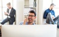 Group of young businesspeople with smartphone working together in a modern office. Royalty Free Stock Photo