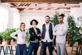 Group of young businesspeople standing in office, looking at camera. Royalty Free Stock Photo