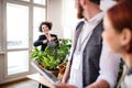 Group of young businesspeople with tablet in office, start-up concept. Royalty Free Stock Photo