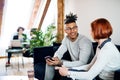 Group of young businesspeople talking in office, start-up concept. Royalty Free Stock Photo