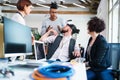 Group of young businesspeople talking in office, start-up concept. Royalty Free Stock Photo