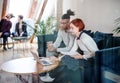 Group of young businesspeople using laptop in office, start-up concept. Royalty Free Stock Photo