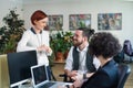 Group of young businesspeople using laptop in office, start-up concept. Royalty Free Stock Photo