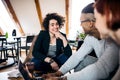 Group of young businesspeople using laptop in office, start-up concept. Royalty Free Stock Photo