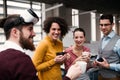 A group of young businesspeople with VR goggles in office, talking. Royalty Free Stock Photo