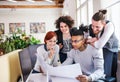 Group of young businesspeople working in office, start-up concept. Royalty Free Stock Photo