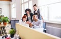 Group of young businesspeople working in office, start-up concept. Royalty Free Stock Photo