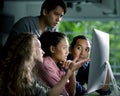 Group of young businesspersons looking intently at the screen Royalty Free Stock Photo