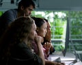 Group of young businesspersons looking intently at the screen Royalty Free Stock Photo