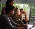 Group of young businesspersons looking intently at the screen Royalty Free Stock Photo