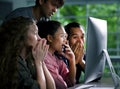 Group of young businesspersons looking intently at the screen Royalty Free Stock Photo