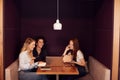 Group Of Young Businesswomen Sitting Around Table In Modern Workspace Having Working Lunch Meeting Royalty Free Stock Photo