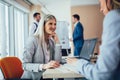 Group of young businesswomen working and communicating while sitting at the office desk together Royalty Free Stock Photo