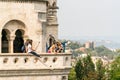 A group of young caucasian male and female tourists standing at a viewpoint outside and below Matthias Church in Budapest. Royalty Free Stock Photo