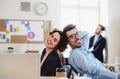 Group of young cheerful businesspeople working together in a modern office. Royalty Free Stock Photo