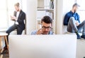 Group of young businesspeople with smartphone working together in a modern office. Royalty Free Stock Photo