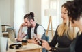 Group of young businesspeople with smartphone working together in a modern office. Royalty Free Stock Photo