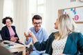 Group of young businesspeople working together in a modern office. Royalty Free Stock Photo