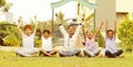 Group of young children cheering up at park - teens having fun during summer vacation - Multi ethnicity children playing