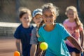 Energetic Kids Engage in Intense Tennis Match