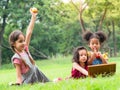 A group of young children of many nationalities play and eating fruits outside of school Royalty Free Stock Photo